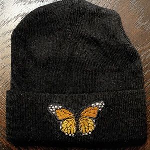 Black hat with customized butterfly detailing